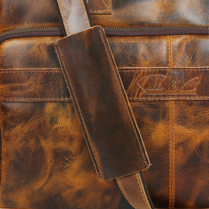 Close-up of a brown leather bag with visible branding