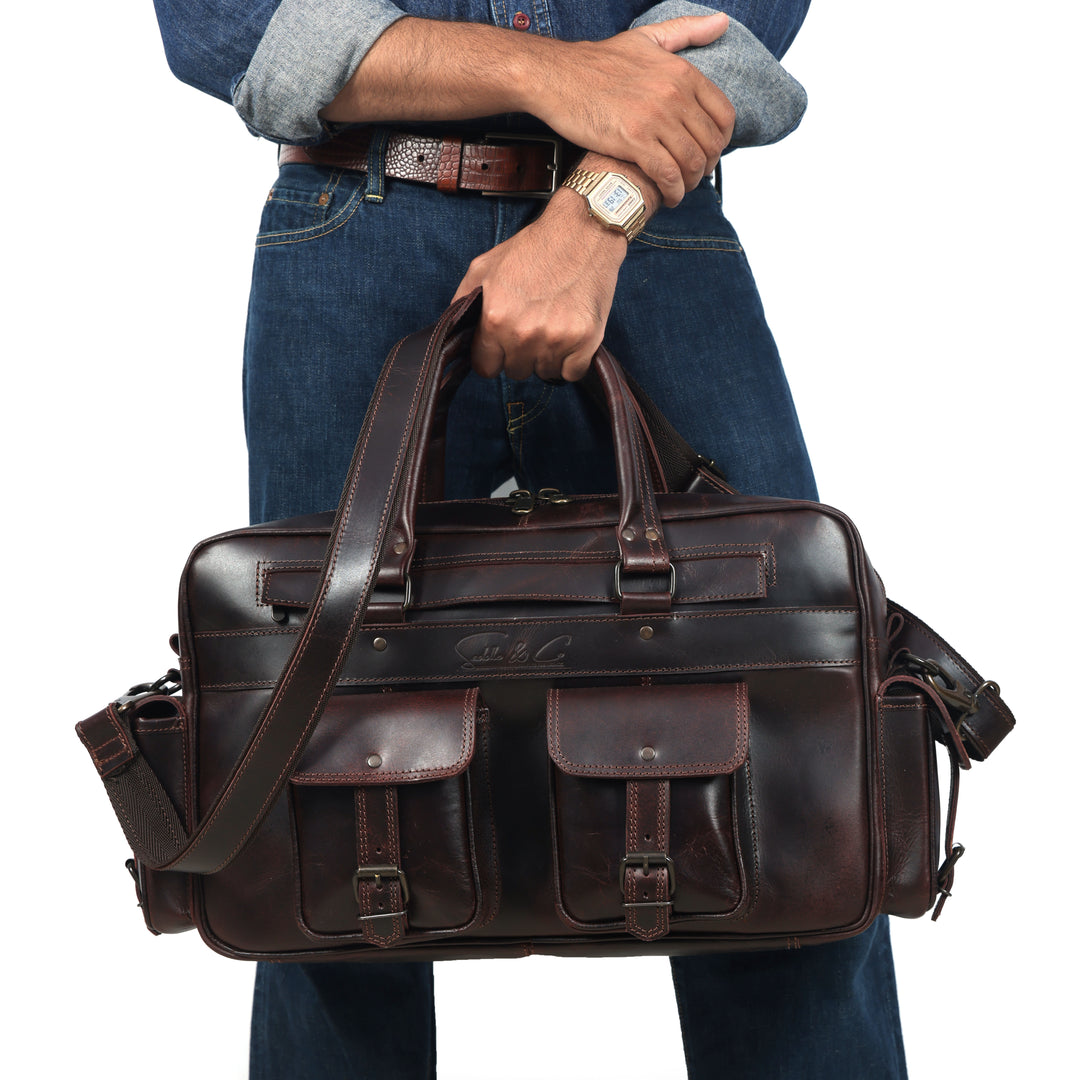 Man holding a brown leather briefcase against a white background