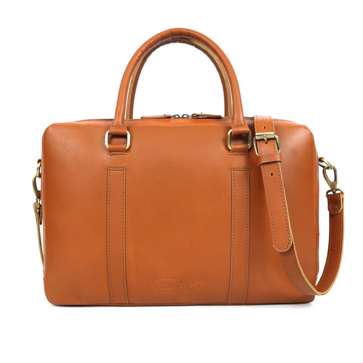 Brown leather handbag with gold accents on a white background