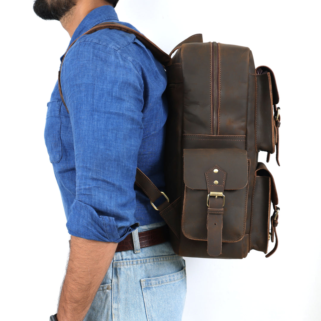 Man wearing a brown leather backpack on a white background