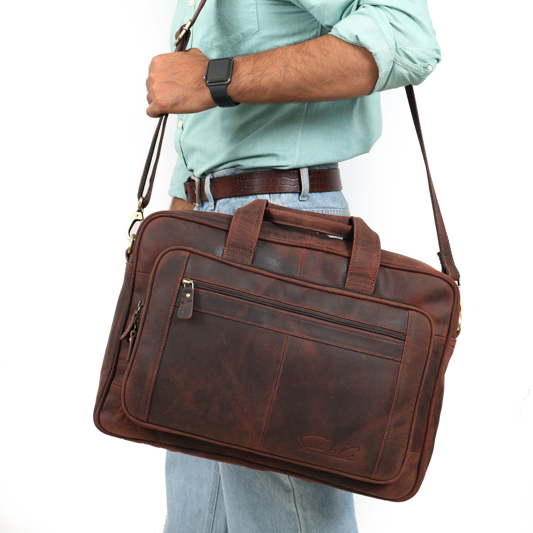 Man carrying a brown leather briefcase on a white background