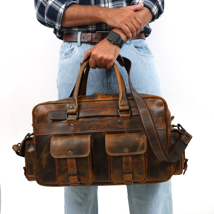 Brown leather briefcase held by a person wearing a plaid shirt and jeans on a white background