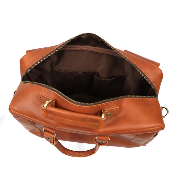 Brown leather duffel bag with gold zipper and hardware on a white background
