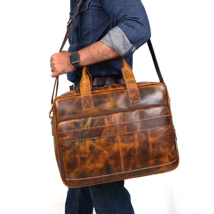 Person holding a brown leather briefcase against a white background