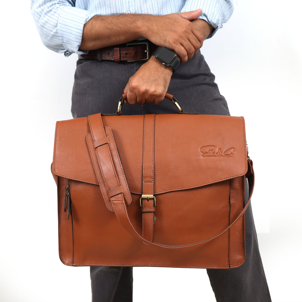 Brown leather briefcase held by a person on a white background