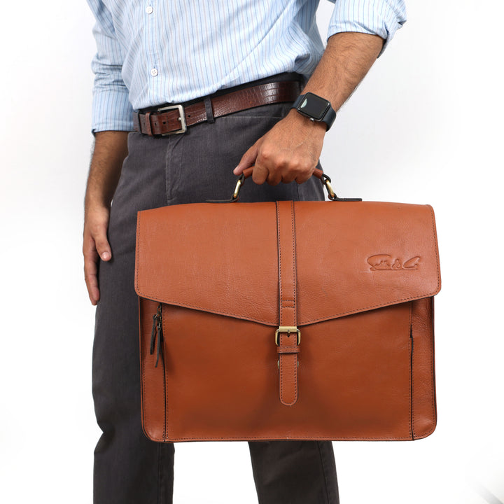 Man holding a brown leather briefcase with a white background