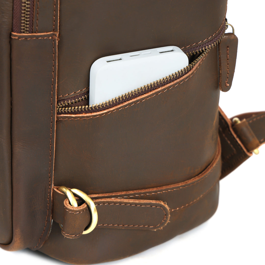 Brown leather backpack with a phone in an open pocket on a white background
