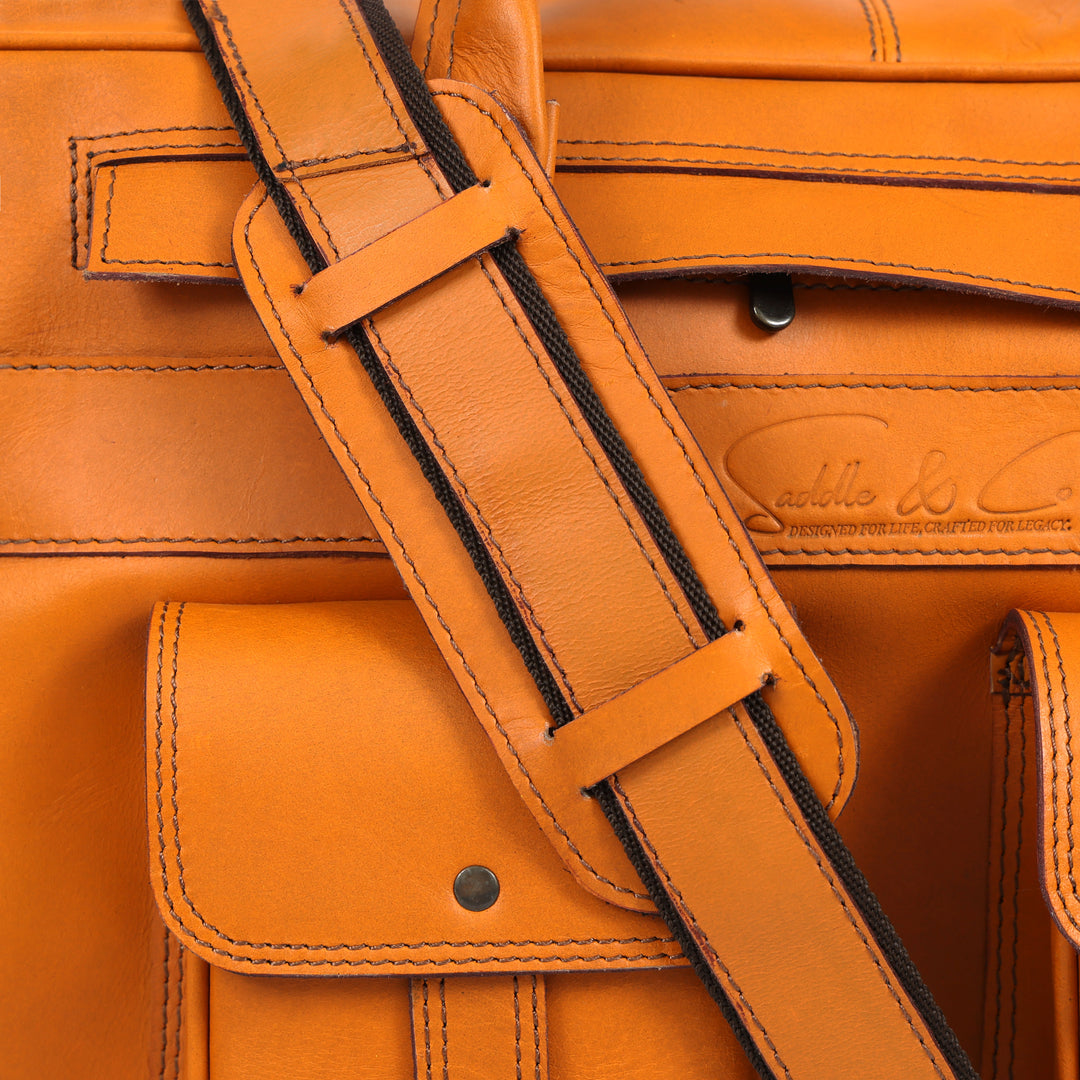 Close-up of a brown leather bag with visible stitching and brand logo.