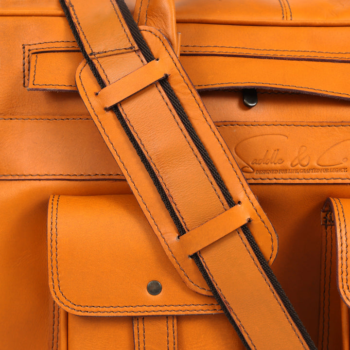 Close-up of a brown leather bag with visible stitching and brand logo.