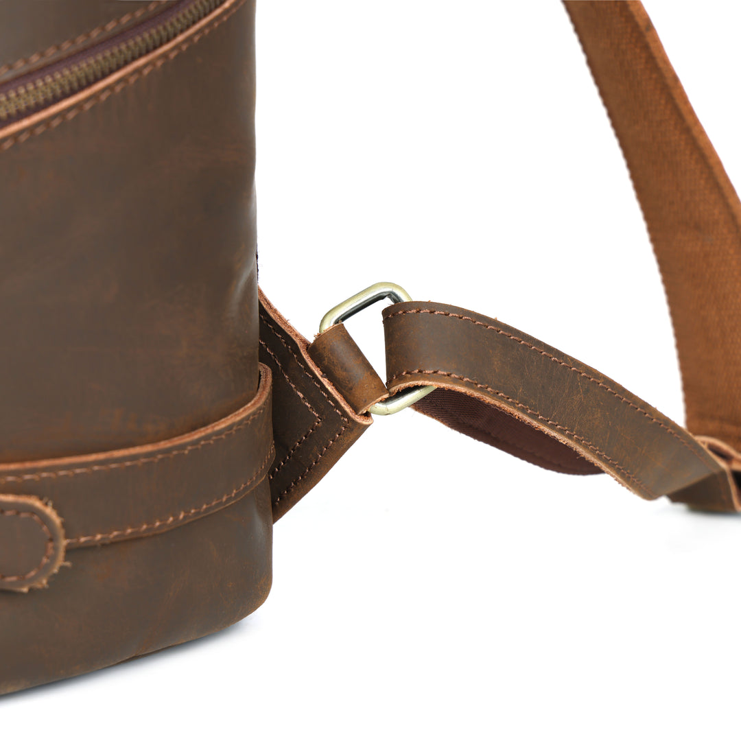 Brown leather bag with strap on a white background