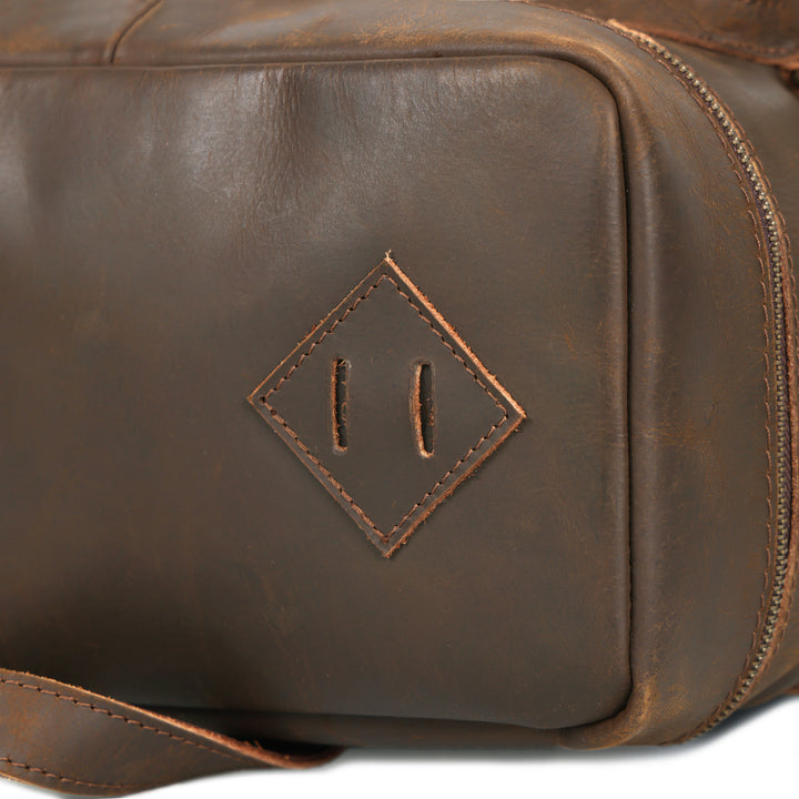 Brown leather dopp kit with a diamond-shaped logo on a white background