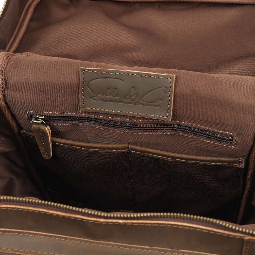 Close-up of a brown leather bag with a visible brand logo.