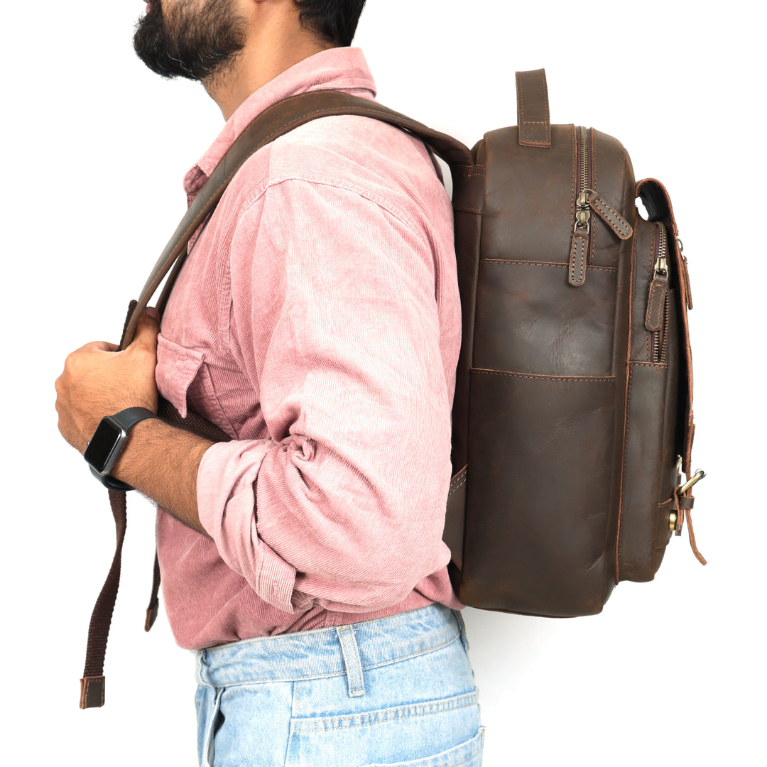 Man wearing a brown leather backpack on a white background