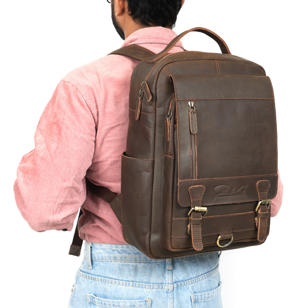 Person wearing a brown leather backpack on a white background